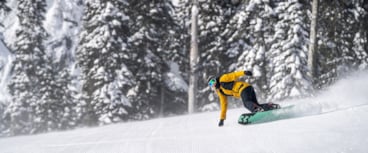 snowboarder making turn with Remedy Pass