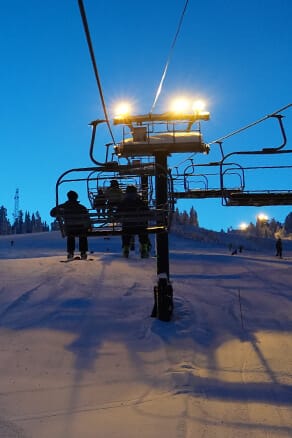 Group riding the lift at night